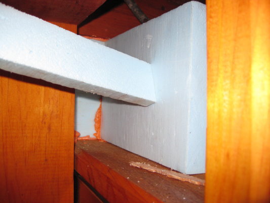 Using a scrap as a clamp while foam cures