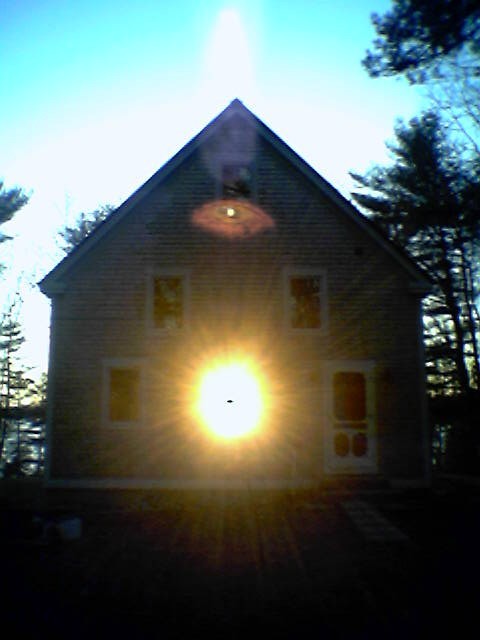 Sun shining through the house seen from outside